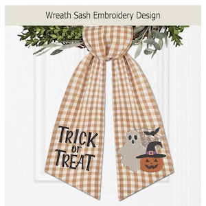 May include: A tan and white gingham wreath sash featuring the embroidered text Trick or Treat on one side and a ghost, a jack-o'-lantern wearing a witch hat, a spider web, and a bat on the other side, draped over a green leafy wreath.