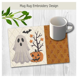 May include: A rectangular mug rug featuring an embroidered Halloween design with a white ghost, an orange jack-o'-lantern, a black bat, and a bare tree with orange leaves on a cream diamond-patterned background, next to a white ceramic mug.