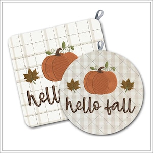 May include: Two fall-themed pot holders. One is square, the other round. Both have a cream-colored plaid pattern with embroidered pumpkins, leaves, and the words "hello fall". Each has a loop for hanging.