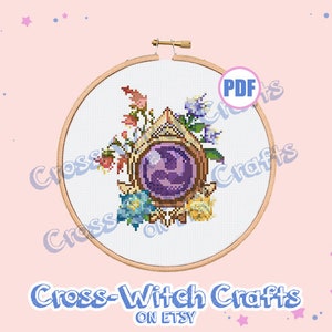 May include: A cross stitch pattern featuring a purple crystal orb surrounded by flowers and vines. The pattern is framed in a wooden hoop and is available as a PDF download. The text "Cross-Witch Crafts on Etsy" is at the bottom of the image.