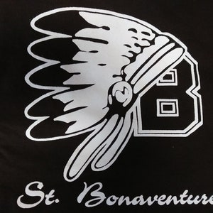 May include: Black and white graphic of a Native American headdress with a large number "8" in the background. The text "St. Bonaventure" is written below the graphic.