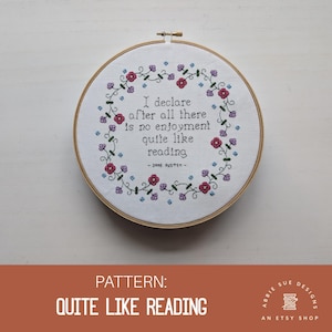 May include: A white embroidery hoop with a floral border and the quote "I declare after all there is no enjoyment quite like reading - Jane Austen" in black thread.
