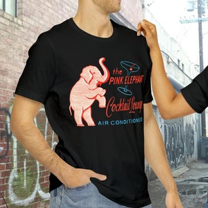 Retro Pink Elephant Cocktail Lounge on a Unisex Bella+Canvas Short Sleeve Tee. Get that Dive Bar vibe going