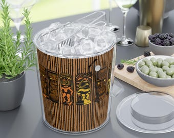 May include: Clear ice bucket with a bamboo-style design and colorful tiki illustrations. The bucket is filled with ice cubes and includes clear tongs. A clear lid sits nearby. Perfect for a tropical-themed party or bar.