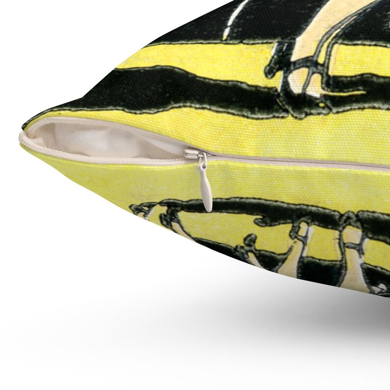 Pode incluir: Uma almofada decorativa com um design art d&eacute;co amarelo e preto. A almofada apresenta um fecho de correr e um interior branco. A obra de arte retrata uma imagem estilizada das pernas e p&eacute;s de uma pessoa em preto e branco.