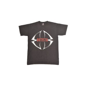 May include: Black t-shirt with a white graphic of a stylized logo with the word "Batista" in red lettering.