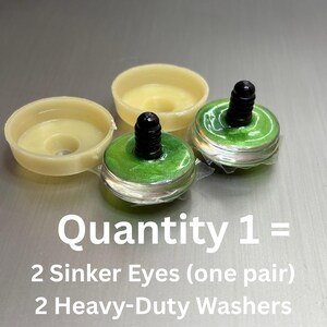 May include: Two green sinker eyes with black stems and two cream-colored heavy-duty washers. The text reads: Quantity 1 = 2 Sinker Eyes (one pair) 2 Heavy-Duty Washers. These components are designed for craft projects requiring secure attachment.