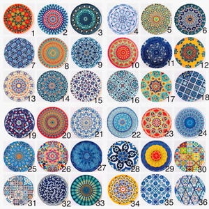 May include: A collection of thirty-six circular ceramic tiles arranged in a grid, each featuring a unique, intricate geometric or floral mandala pattern in a variety of vibrant colors including blue, red, yellow, green, and white.