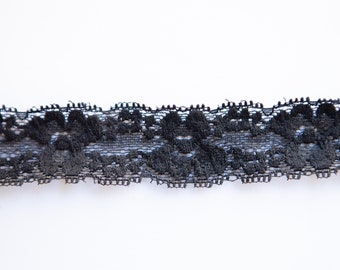 May include: Black lace trim with a delicate floral pattern.