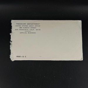 May include: A white envelope with text from the Treasury Department, United States Assay Office, 350 Duboce Street, San Francisco, Calif. 94102. The text "OFFICIAL BUSINESS" is also printed on the envelope. The year "1968" is printed on the envelope.
