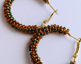 Autumn harvest fall solstice beaded wire wrapped hoop earrings made with orange green and bronze colored glass seed beads