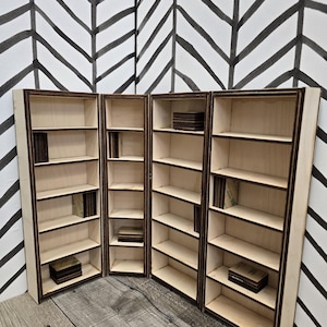 May include: Four wooden bookcases with five shelves each. The bookcases are made of light wood with dark brown trim. The shelves are empty.