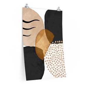 May include: Abstract art print featuring a composition of organic shapes in neutral tones. The design includes black, beige, and gold elements, with a section of small, dotted circles. The artwork is mounted on a white background.