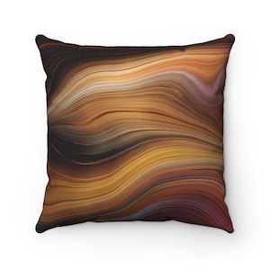 May include: A square throw pillow with a brown, orange, and gold abstract pattern. The pattern resembles swirling lines of agate.