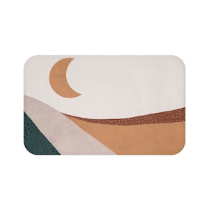 Peut inclure: Tapis de bain abstrait avec un croissant de lune, des collines brunes, orange et vertes, et des pois blancs.