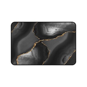 May include: Black and white agate pattern with gold glitter accents. The pattern resembles a swirling, abstract design.