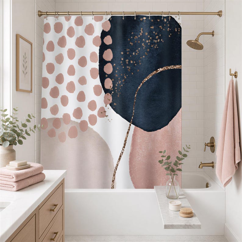 a bathroom with a shower curtain featuring a bold abstract design in shades of blue, pink, and white. The shower curtain is hanging above a white bathtub, which is adorned with a vase of greenery and a towel. The bathroom also includes a sink and a mirror, creating a cohesive and stylish space.