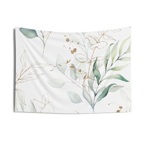May include: A white tapestry with a watercolor pattern of green leaves and gold accents.
