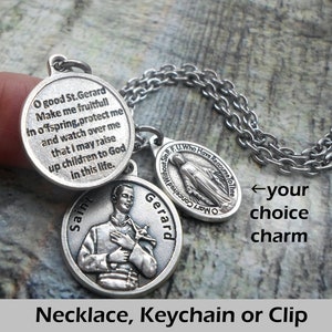 May include: Silver tone necklace with three charms. The charms are round and feature a religious image of Saint Gerard, a prayer to Saint Gerard, and a depiction of the Virgin Mary. The necklace is available as a necklace, keychain, or clip.