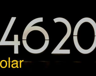May include: A white, illuminated sign with the number 4620 and the word "Solar" in yellow below.