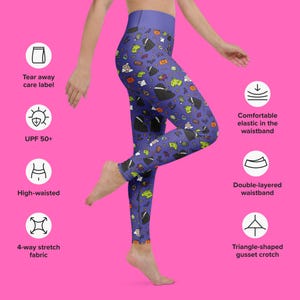 May include: High-waisted leggings with a blue background and a pattern of Halloween-themed cartoon characters. Features include a tear-away care label, UPF 50+ protection, a comfortable elastic waistband, and a double-layered waistband.