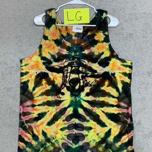 May include: A tie-dye tank top with a black silhouette of a goat wearing a cowboy hat. The tank top has a yellow, orange, green, and black tie-dye pattern. The text "LG" and "0932" are visible on the tag.