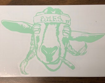 May include: A light green sticker featuring a cartoon goat with a bandana that says "B.M.E.S."