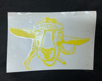 May include: Yellow vinyl sticker of a goat wearing a bandana with the text "B.M.E.S." on it.