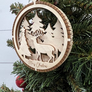 This is a round wooden Christmas ornament with a winter scene with a living hinge. It depicts nature at its finest.
