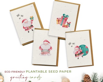May include: Set of four eco-friendly plantable seed paper Christmas greeting cards featuring watercolor illustrations of Santa Claus. The cards have a brown kraft paper backing and say "Ho Ho Ho" on two of the cards.