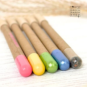 May include: Five cardboard pencils with colorful caps. The caps are pink, yellow, green, blue, and black. The pencils are all brown and have a natural look. The text "LITTLE GREEN PAPER SHOP" is visible in the top right corner of the image.