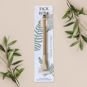 May include: A plantable pen and paper set with the text "JACK ROSE 07 326". The pen is made of light brown paper and is packaged in a white card with fern illustrations. The card also includes the text "PLANT ME AND WATCH OUR LOVE GROW!"