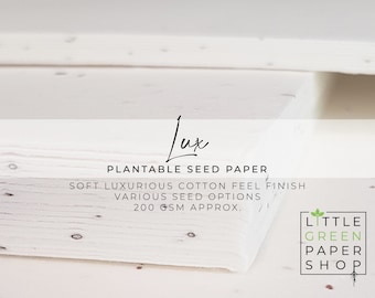 May include: Close-up of a stack of white plantable seed paper with a soft, luxurious cotton feel finish. The paper is 200 gsm and has various seed options. The text "Lux Plantable Seed Paper" is visible at the top of the image. The text "LITTLE GREEN PAPER SHOP" is visible at the bottom right of the image.