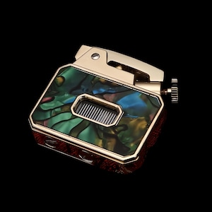 May include: A gold-colored lighter with a rectangular body and a hinged top. The lighter features a colorful, iridescent panel with shades of green, blue, and yellow. The design includes a small rectangular window and a textured wheel for ignition.