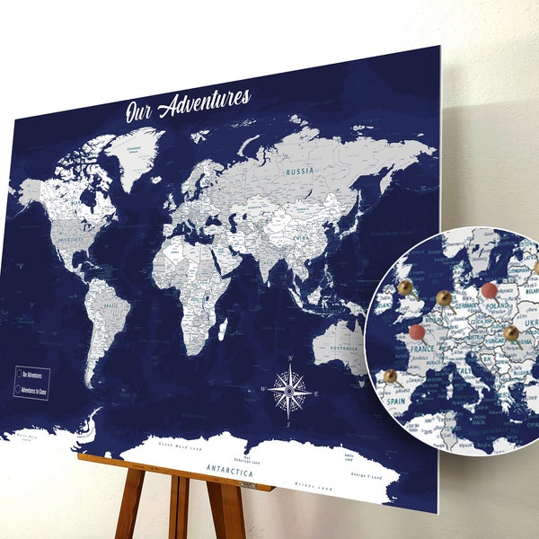 May include: A blue and white world map with push pins marking locations on the map. The map is on a wooden easel. The text "Our Adventures" is at the top of the map. The map is zoomed in on Europe, showing pins in Poland, Ukraine, and Russia.