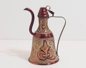 Vintage copper amphora with refined decorations