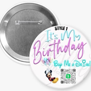 May include: A white button with the text "It's My Birthday" in blue and purple script, along with "Buy Me A Drink!" in teal. Features a Mickey Mouse graphic and a QR code. The button is round with a pin back.