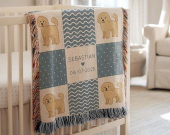 May include: A beige and blue baby blanket with a dog pattern, displayed on a white crib. The blanket features a patchwork design with dog illustrations, wavy lines, and polka dots. The center square has the name "SEBASTIAN" and the date "06-07-2025".