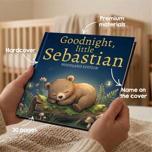 May include: A hardcover children's book titled "Goodnight, little Sebastian" with a woodland theme. The cover features a sleeping brown bear illustration. The book has 30 pages and is made with premium materials.