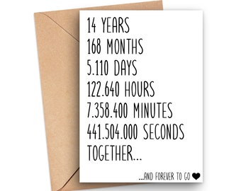 May include: A white card with black text that reads "14 YEARS 168 MONTHS 5.110 DAYS 122.640 HOURS 7.358.400 MINUTES 441.504.000 SECONDS TOGETHER... ...AND FOREVER TO GO" with a black heart symbol.
