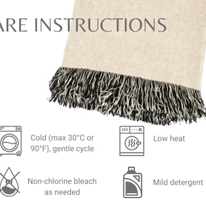 May include: A beige textile with black fringe, displaying care instructions. The text includes washing machine symbols, temperature guidelines (max 30&deg;C or 90&deg;F), and recommendations for gentle cycles, low heat, non-chlorine bleach, and mild detergent.