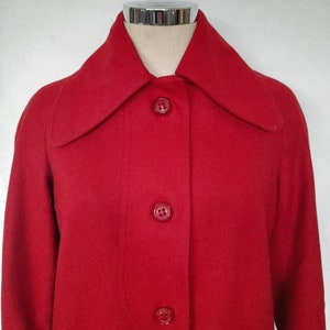 K&ouml;nnte beinhalten: Ein roter Wollmantel mit Kragen und f&uuml;nf Kn&ouml;pfen vorne.