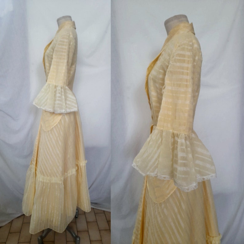 May include: A yellow vintage dress with a striped pattern and lace trim. The dress has a long skirt with ruffles and a fitted bodice with a collar.
