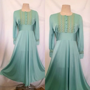 May include: A long-sleeved, light blue maxi dress with a lace trim and button-up front.