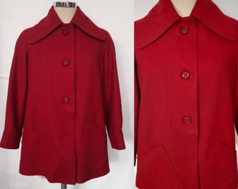 May include: A red vintage wool coat with a large collar and button closure. The coat has two patch pockets on the front.