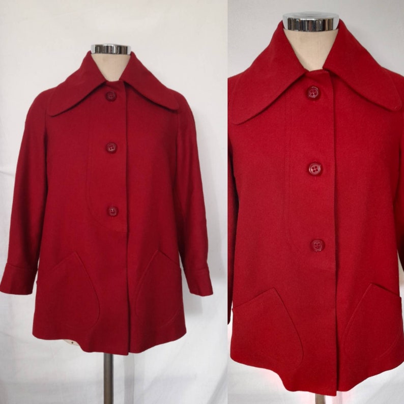 K&ouml;nnte beinhalten: Ein roter Vintage-Wollmantel mit gro&szlig;em Kragen und Knopfleiste. Der Mantel hat zwei aufgesetzte Taschen auf der Vorderseite.