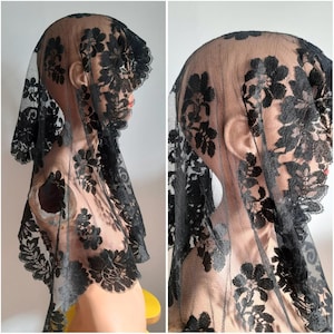 May include: Black lace veil with floral pattern. The veil is sheer and delicate, with a scalloped edge.