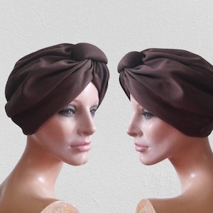 May include: Two brown turban headbands with a gathered fabric design. The headbands are made of a soft, pliable material.