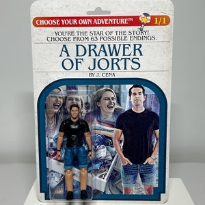 Un cassetto di Jorts Scegli la tua avventura A tema Commedia Action Figure personalizzata - Carta bifacciale - Libro retrò - Jorts Suck