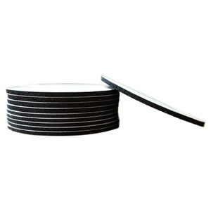 May include: A stack of round black and white coasters. The coasters are made of a soft material and have a smooth surface.